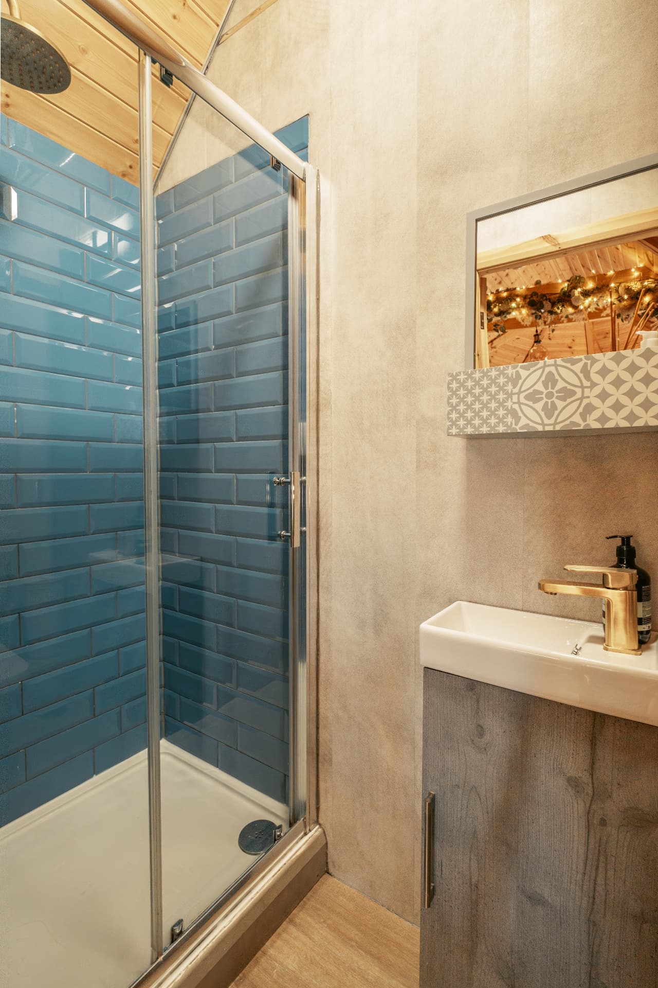 Blue-tiled walk-in shower in The Mallard