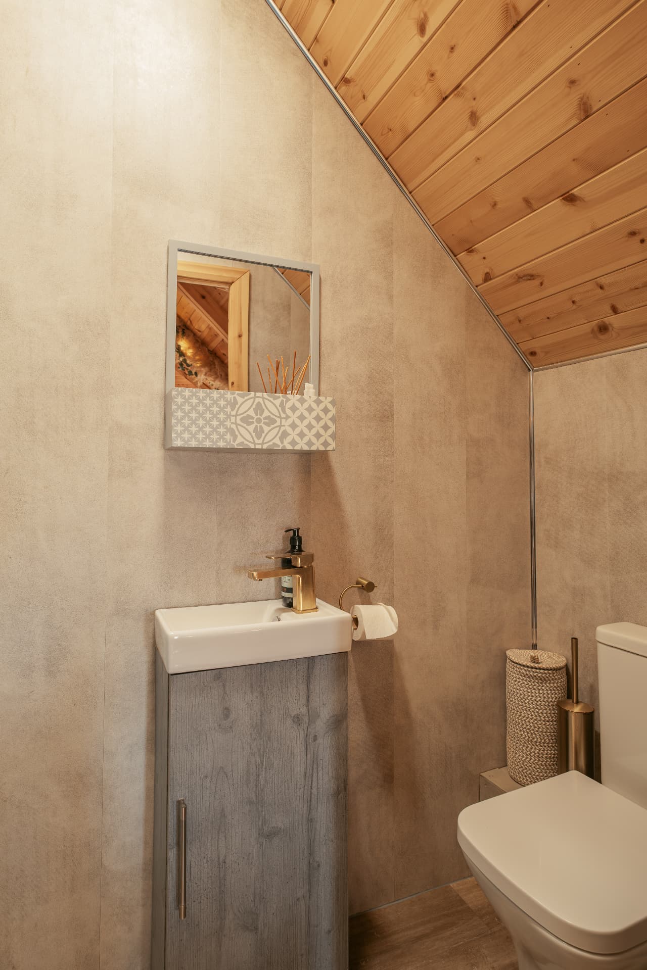 Bathroom in The Mallard with brass taps and a woven basket