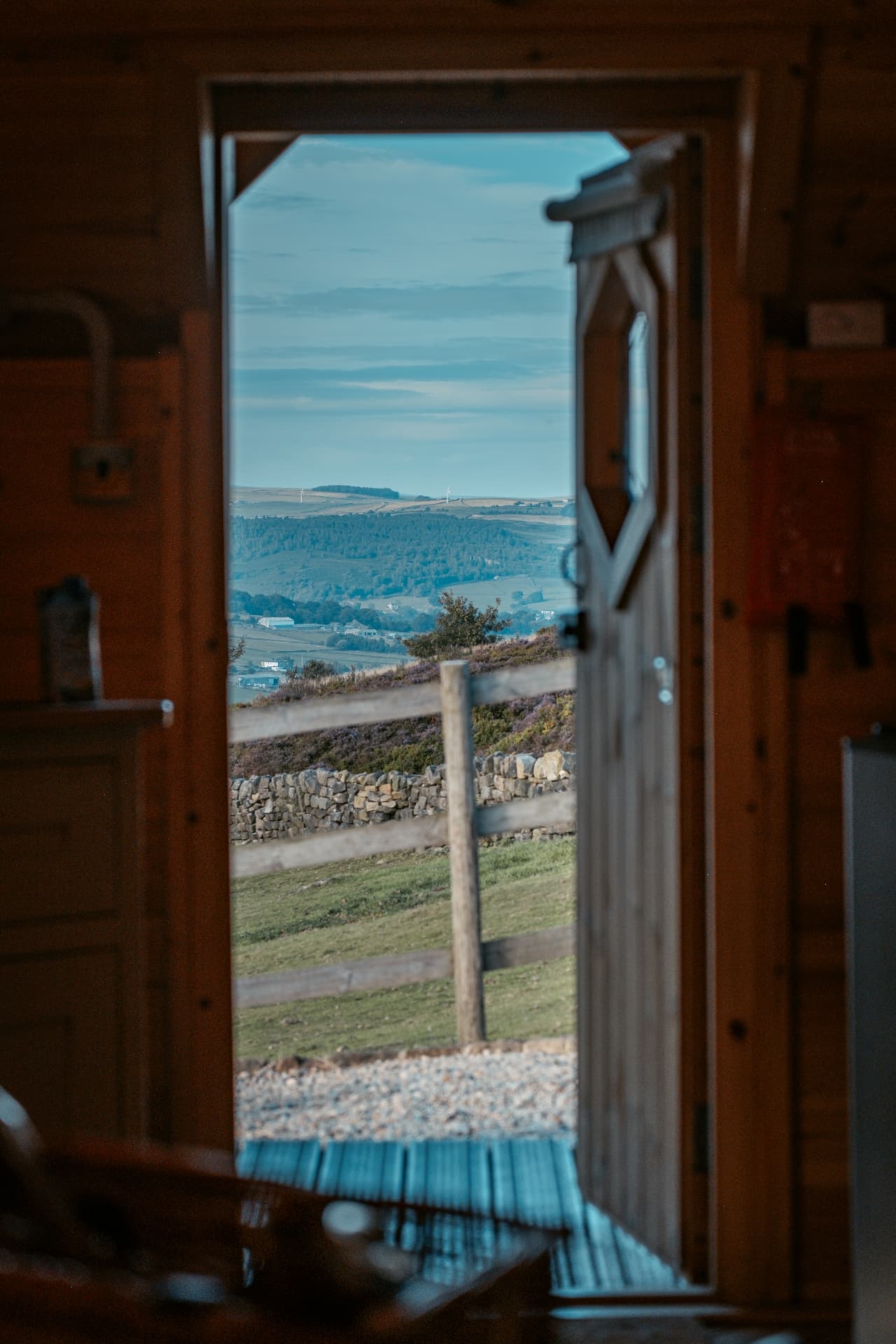 The Yorkshire valley seen through an open cabin door in the morning